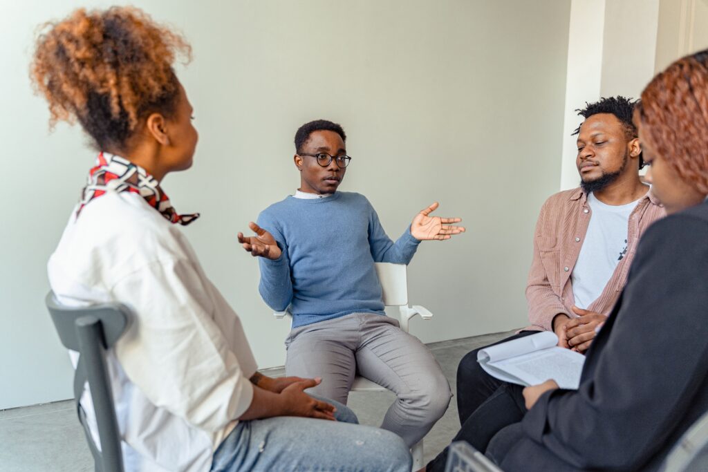 Adults speaking with a clinician during a residential mental health therapy session