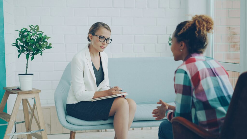 Therapist listening to an adult during an individual mental health assessment